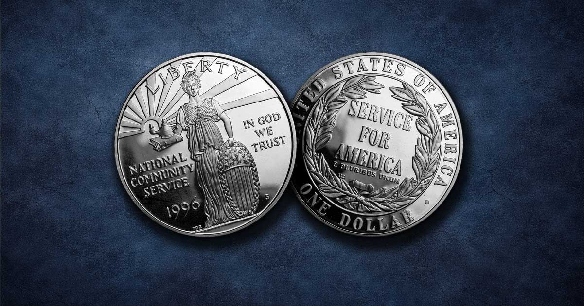 Two National Community Service Silver Dollars on a table.