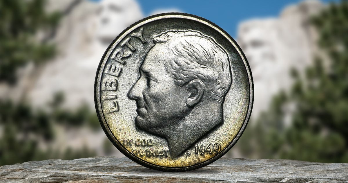 A Roosevelt Dime sitting on a rock surface.