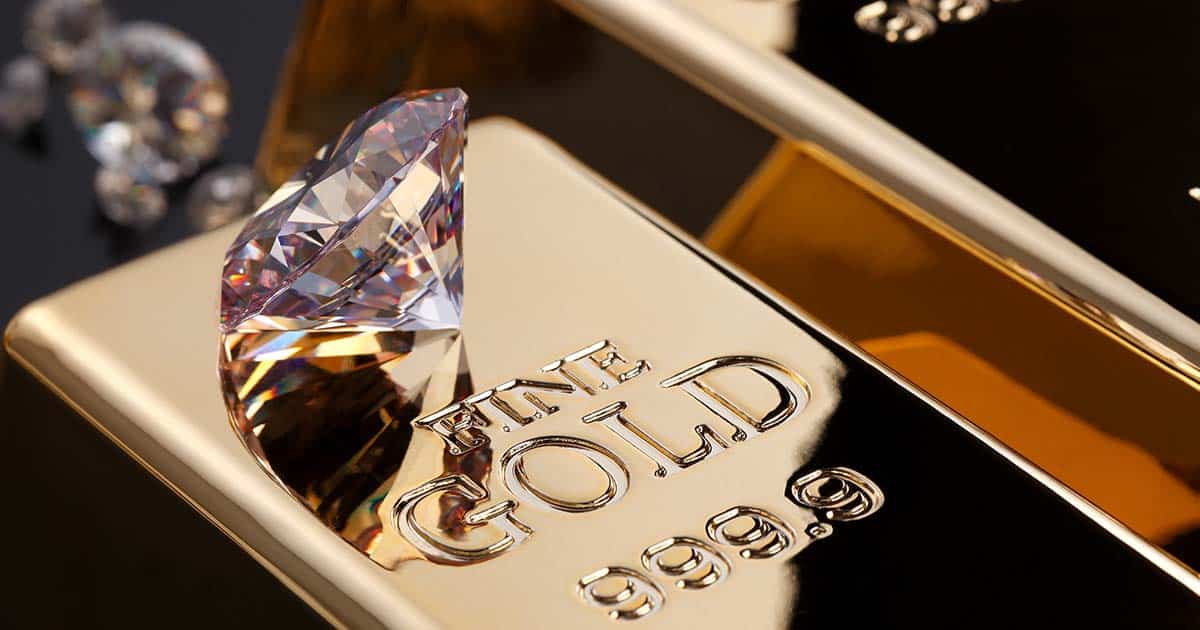 A diamond on top of a gold bar for an article titled "Investing in Diamonds vs Gold; A Comparative Analysis".