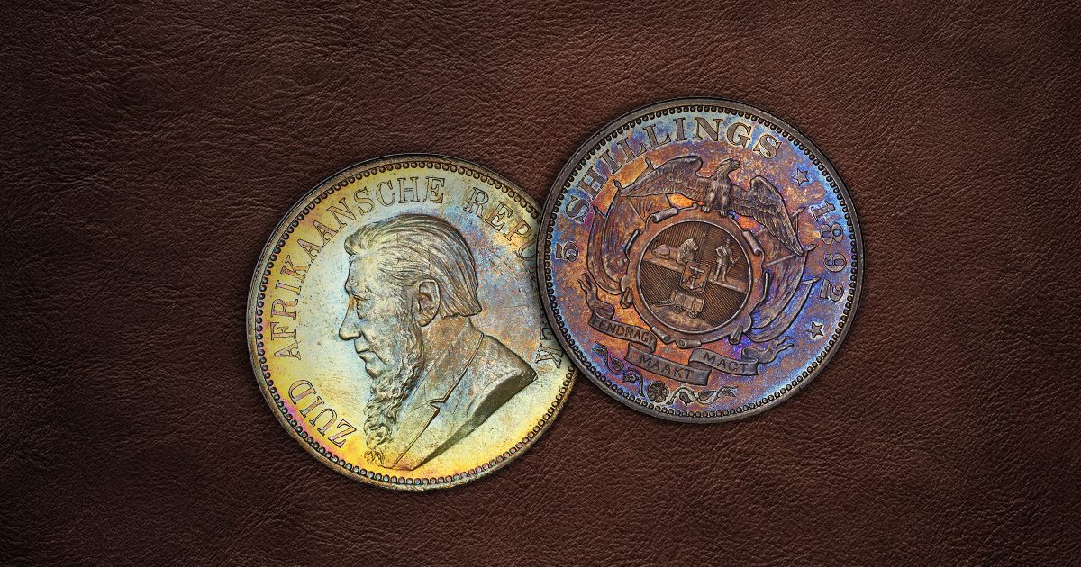 An 1892 Silver South African Shilling with colorful toning is shown obverse and reverse.