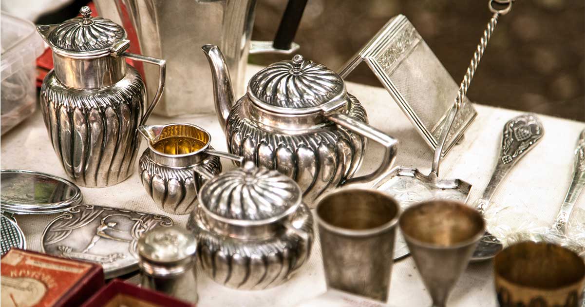 A collection of antique silver pots and containers.