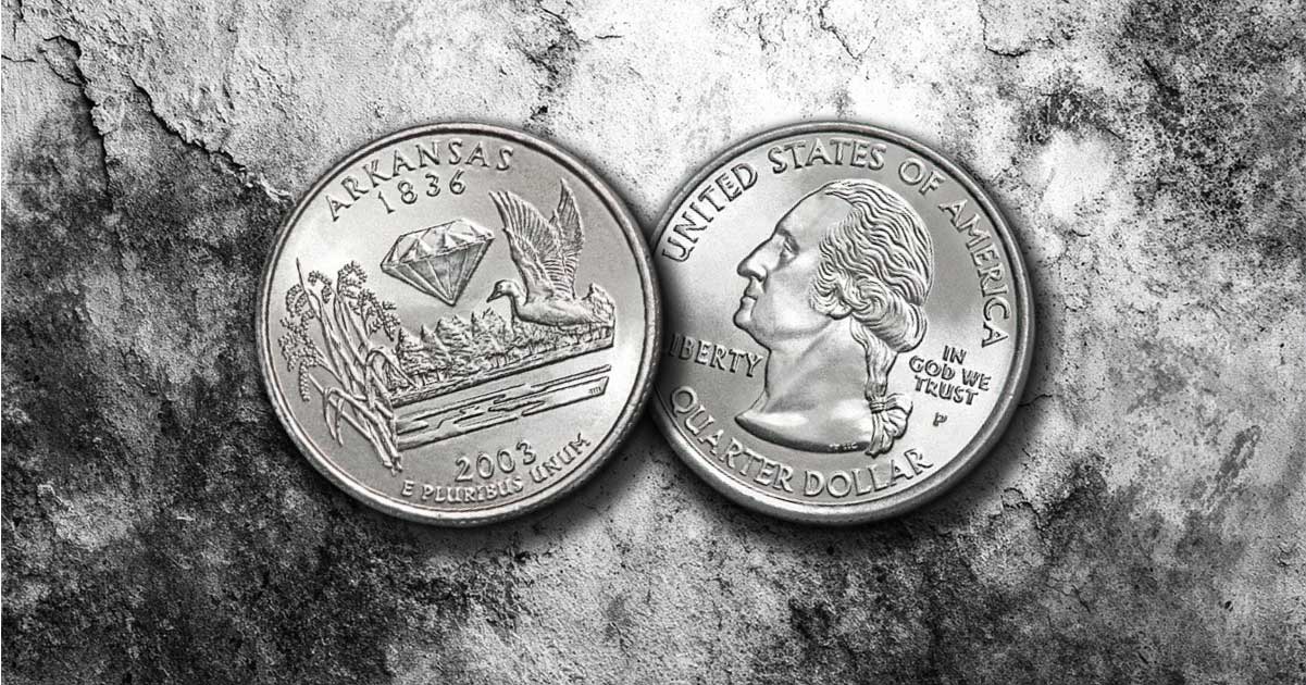 Two Arkansas state quarters on a table.