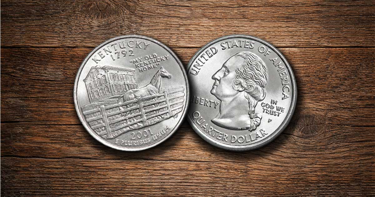 Two Kentucky state quarters on a table.