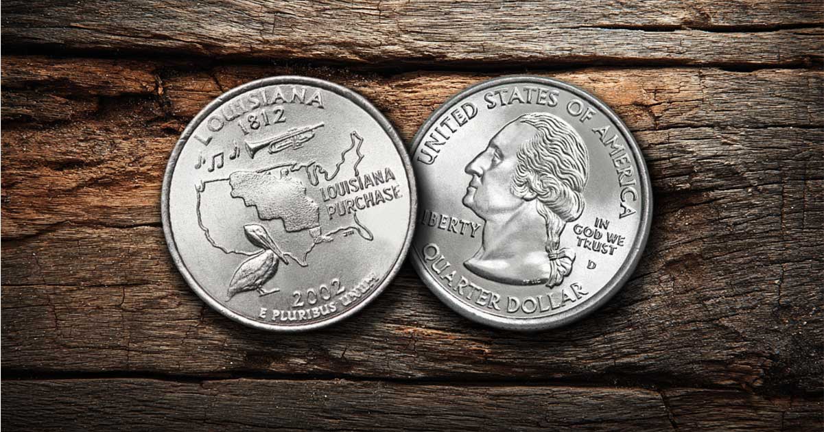Two Louisiana state quarters on a table.