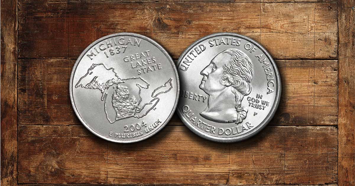 Two Michigan state quarters on a table.