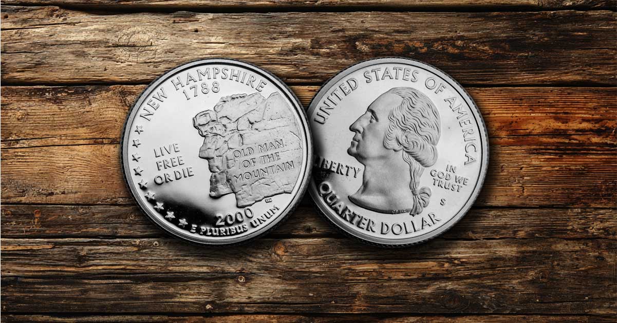 Two New Hampshire state quarters on a table.