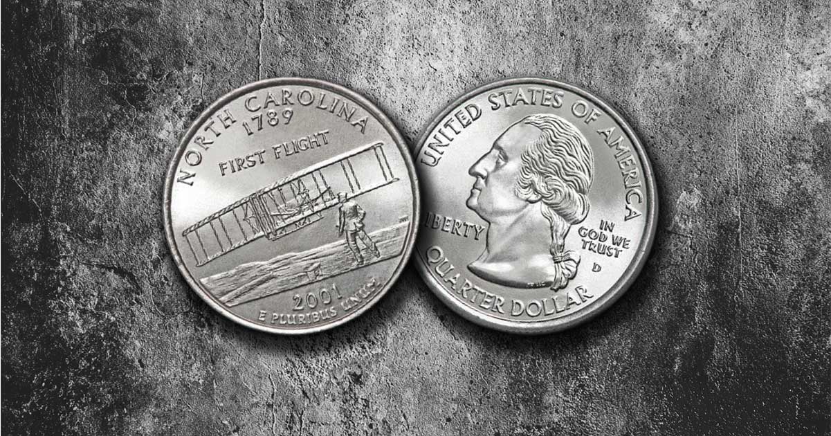 Two North Carolina state quarters are on a table.