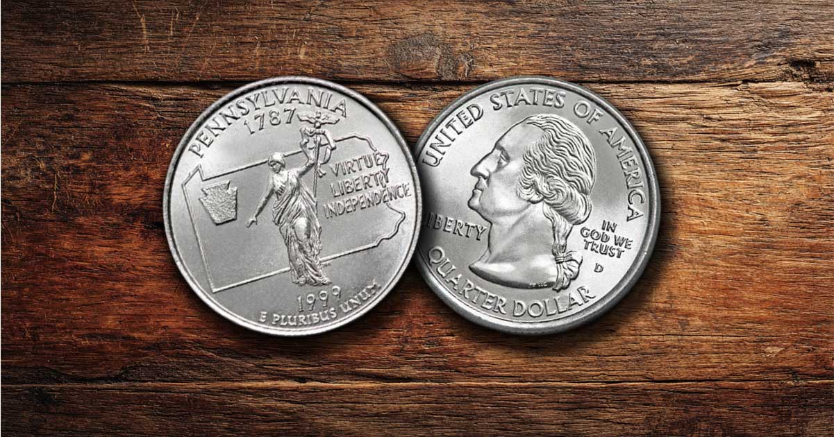 Two Pennsylvania state quarters on a table.