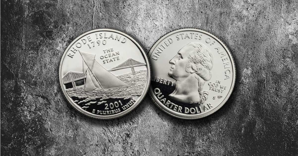 Two Rhode Island state quarters on a table.