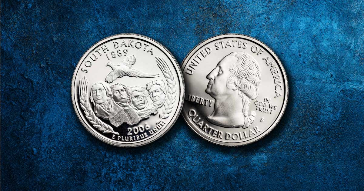 Two South Dakota quarters on a table.